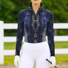 Model wearing the Celestial Cloud Mandala Print Riding Top at an outdoor equestrian arena, with jumps in the background
