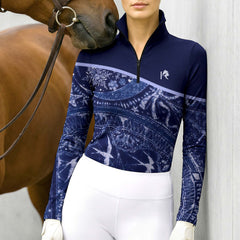 Model wearing the Celestial Night Print Color-Block Riding Top at the stable, with a chestnut horse
