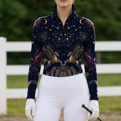 Outdoor farm fence arena shot of female rider wearing midnight navy celestial pegasus constellation galaxy long‑sleeve riding top