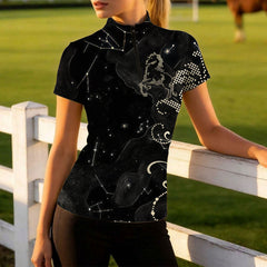 Model leaning against white wooden pasture fencing to showcase the tailored fit and celestial print details
