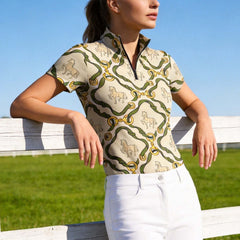 Model leaning on white wooden pasture fence wearing classic tack print riding shirt under bright blue sky