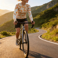 Front view flat shot of women full zip long sleeve cycling jersey with full coverage two-tone orange wavy curve print, peach collar isolated white background
