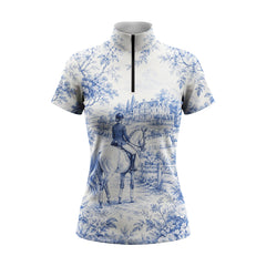 White background studio shot of off-white base Delft blue equestrian manor toile short sleeve quarter zip riding top