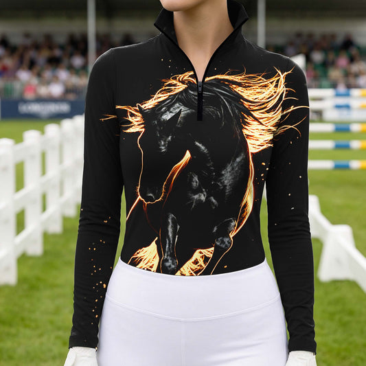 Model wearing bold luminous fire stallion graphic riding top at outdoor equestrian show jumping arena with spectator stands
