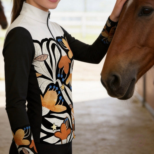 White background studio product shot of full black white color block folk art orange floral star decorative horse print long sleeve quarter-zip riding top
