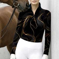 Model wearing luxury gold line art riding top beside a brown horse leaning against light stable wall