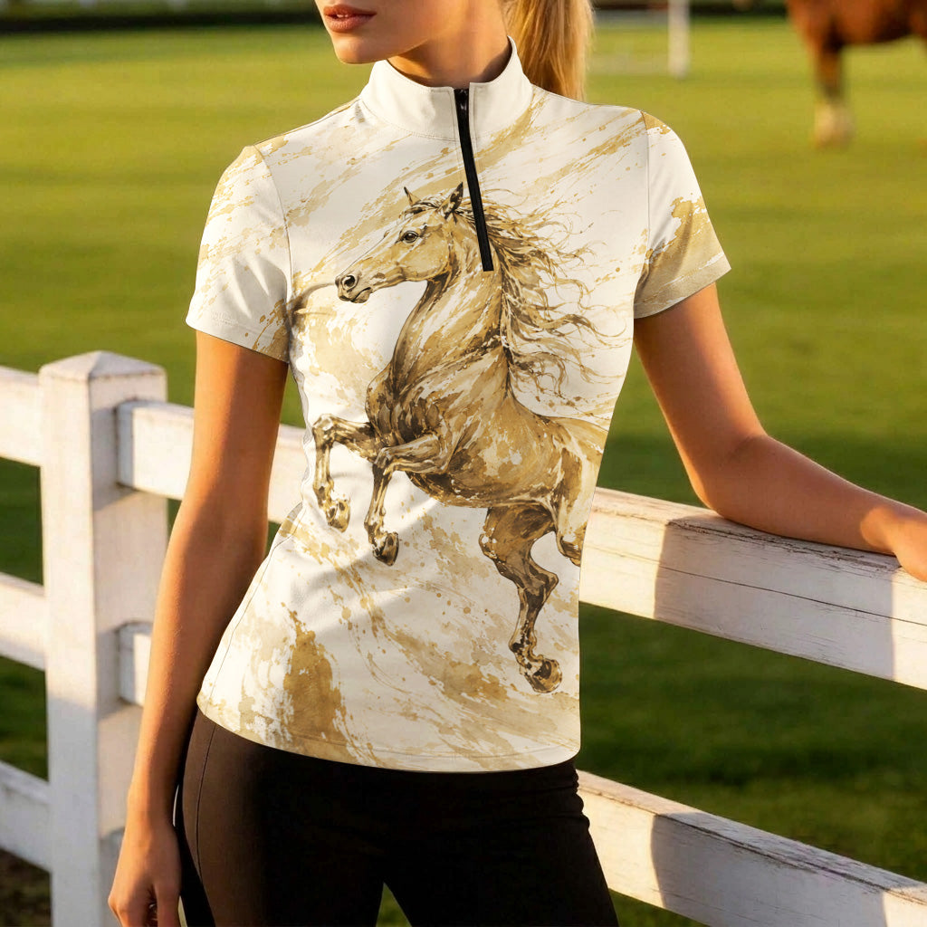 Side model shot leaning on white wooden pasture fence wearing elegant golden watercolor running horse short sleeve riding top in sunlit green grass field
