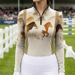 Outdoor equestrian show‑ground shot of female rider wearing cream tan color‑block galloping horse herd print long‑sleeve riding top
