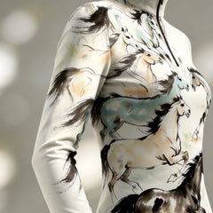 Close-up shot showing fluid brushstroke ink horse print detailing on sleeve and torso of riding top