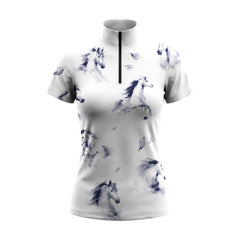 Bright sunlit white wooden stable walkway shot of model walking wearing crisp white scattered misty navy ink wash galloping horse leaf graphic equestrian short sleeve top