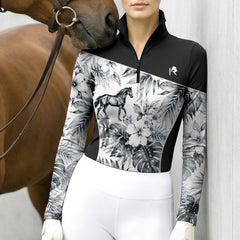 Model wearing the Monochrome Tropical Horse Print Riding Top at the stable, with a chestnut horse
