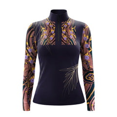 Model gently touching brown horse’s face wearing sophisticated navy color block abstract floral gold art long sleeve riding top in sunlit pasture

