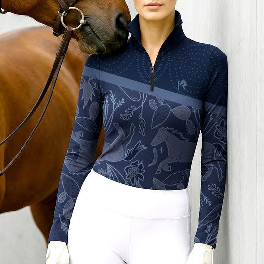 Person wearing a navy long-sleeve equestrian shirt with horse pattern, standing next to a horse.