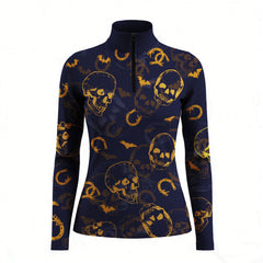Studio white‑background product mockup of women’s navy long‑sleeve quarter‑zip riding top with full golden skull bat horseshoe all‑over print