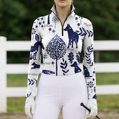 Full-body model shot wearing rustic woodland animal equestrian riding top at sunlit green pasture white wooden fence