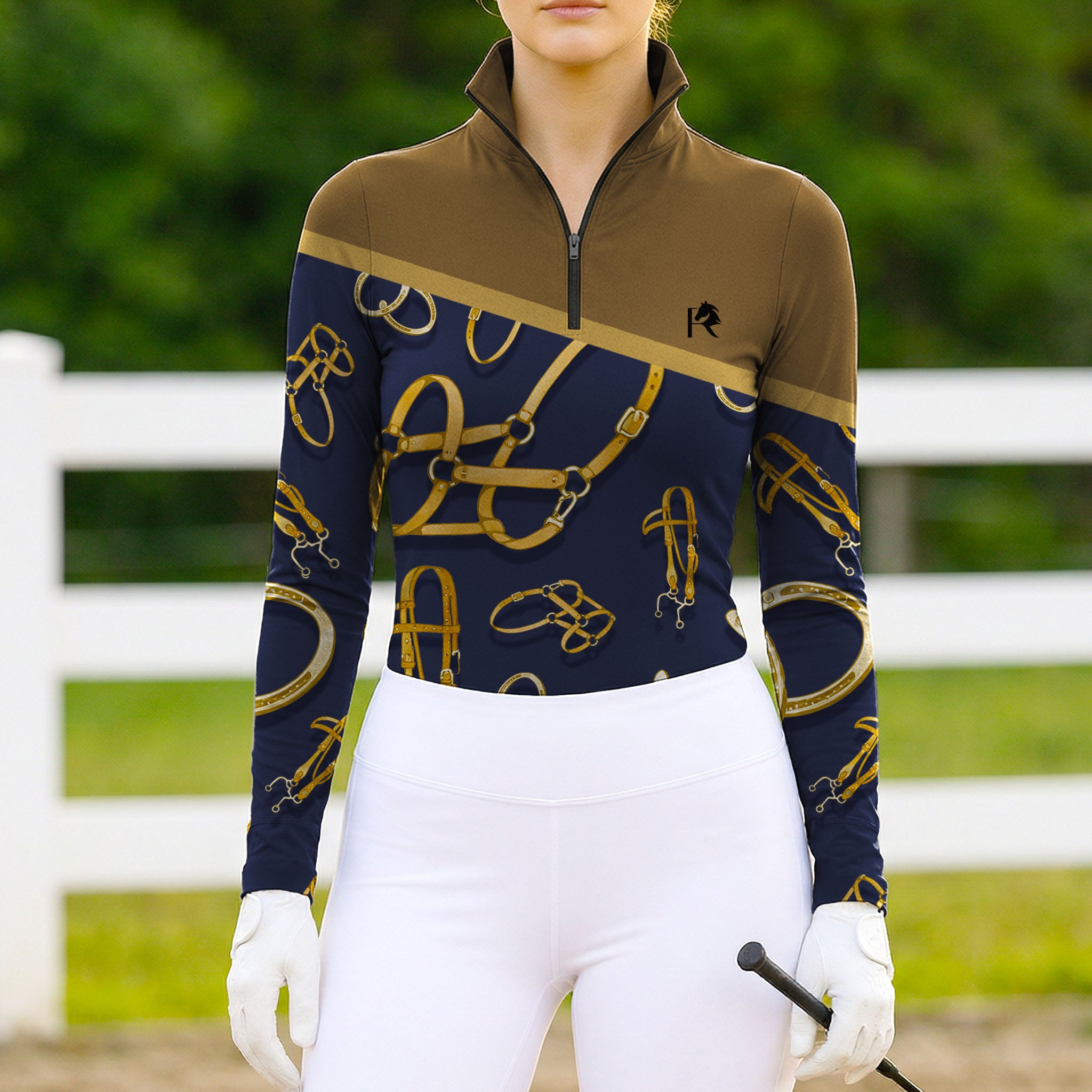 Woman wearing RIDER ATELIER Equestrian Tack Colorblock Quarter-Zip Top at a sunny outdoor pasture, holding a riding crop
