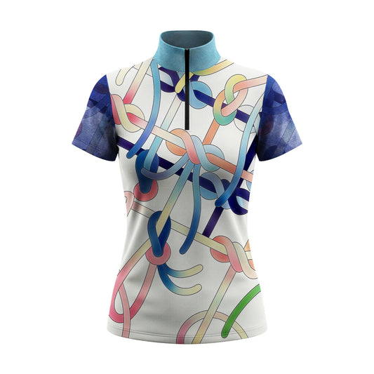 Full-body model shot wearing colorful gradient rope knot two-tone short sleeve top at outdoor equestrian show jumping arena with spectator stands, holding riding crop
