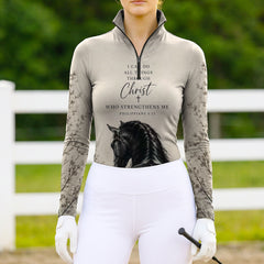 White background studio shot of muted taupe Philippians 4:13 bible verse black stallion floral twig sleeve allover print long sleeve quarter zip riding top
