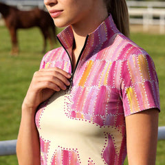 Clean white background studio product shot of pink patchwork galloping horse silhouette short sleeve riding top