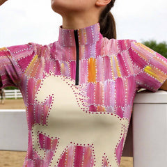 Farm paddock detail shot focusing on stand collar and quarter-zip of colourful patchwork equestrian riding shirt