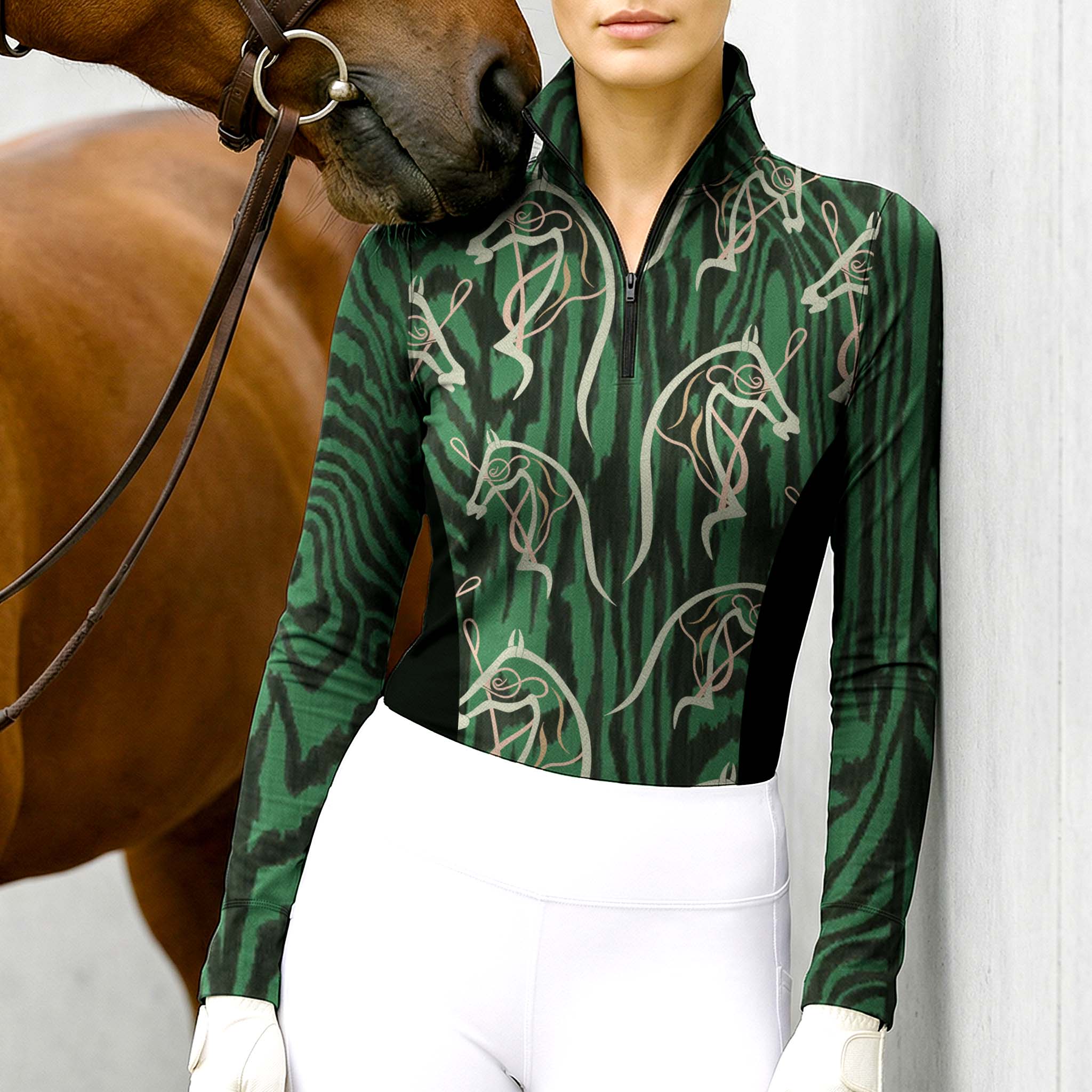 Woman wearing RIDER ATELIER abstract horse head zebra print quarter-zip top with a chestnut horse