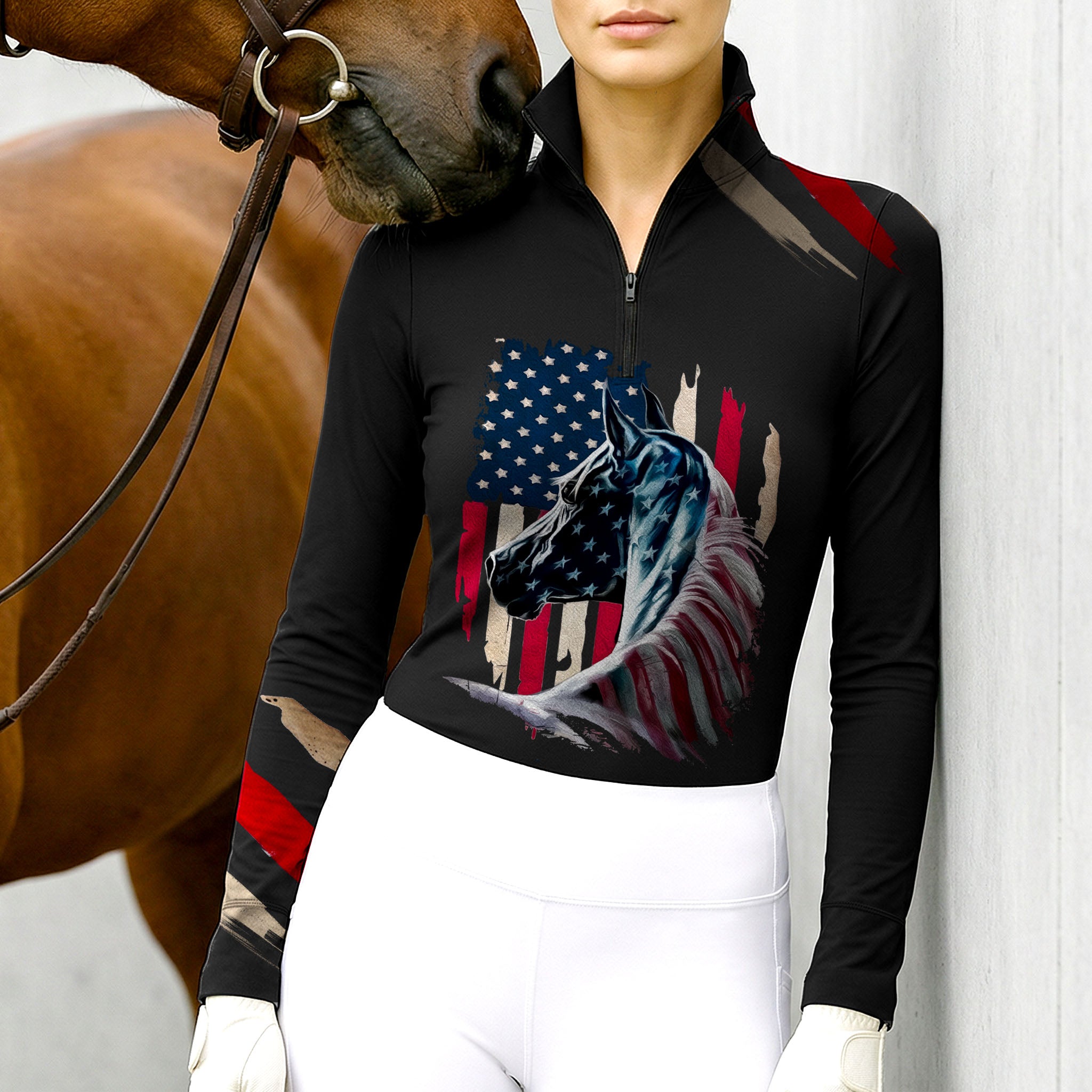 Woman wearing RIDER ATELIER black American flag horse quarter-zip top with a chestnut horse