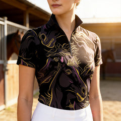 Woman wearing RIDER ATELIER black gold abstract horse print short sleeve top at the ranch during sunset
