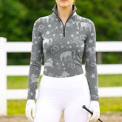 Woman wearing RIDER ATELIER celestial horse gray starry quarter-zip top at the outdoor pasture