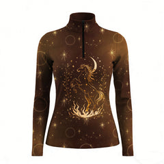 Woman wearing RIDER ATELIER celestial horse quarter-zip top leaning on a wooden fence