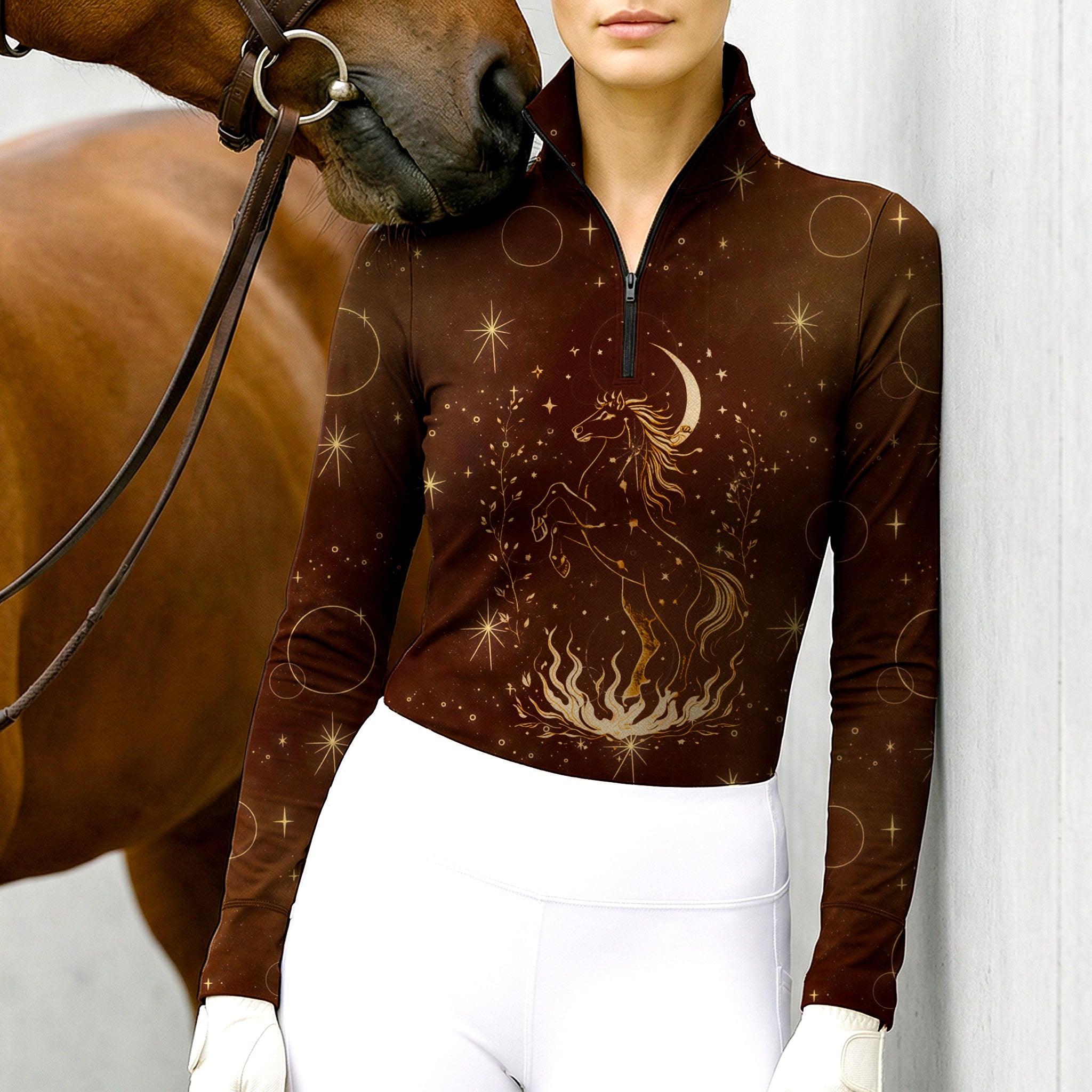 Woman wearing RIDER ATELIER celestial horse quarter-zip top at the outdoor pasture