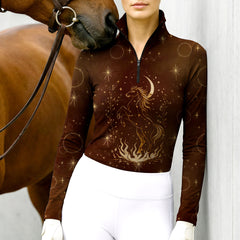 Woman wearing RIDER ATELIER celestial horse quarter-zip top at the outdoor pasture
