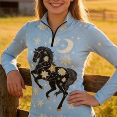 Woman wearing RIDER ATELIER celestial winter quarter-zip top leaning on a fence at sunset
