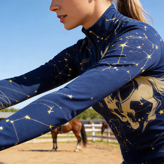 Woman wearing RIDER ATELIER constellation horse quarter-zip top while riding a horse