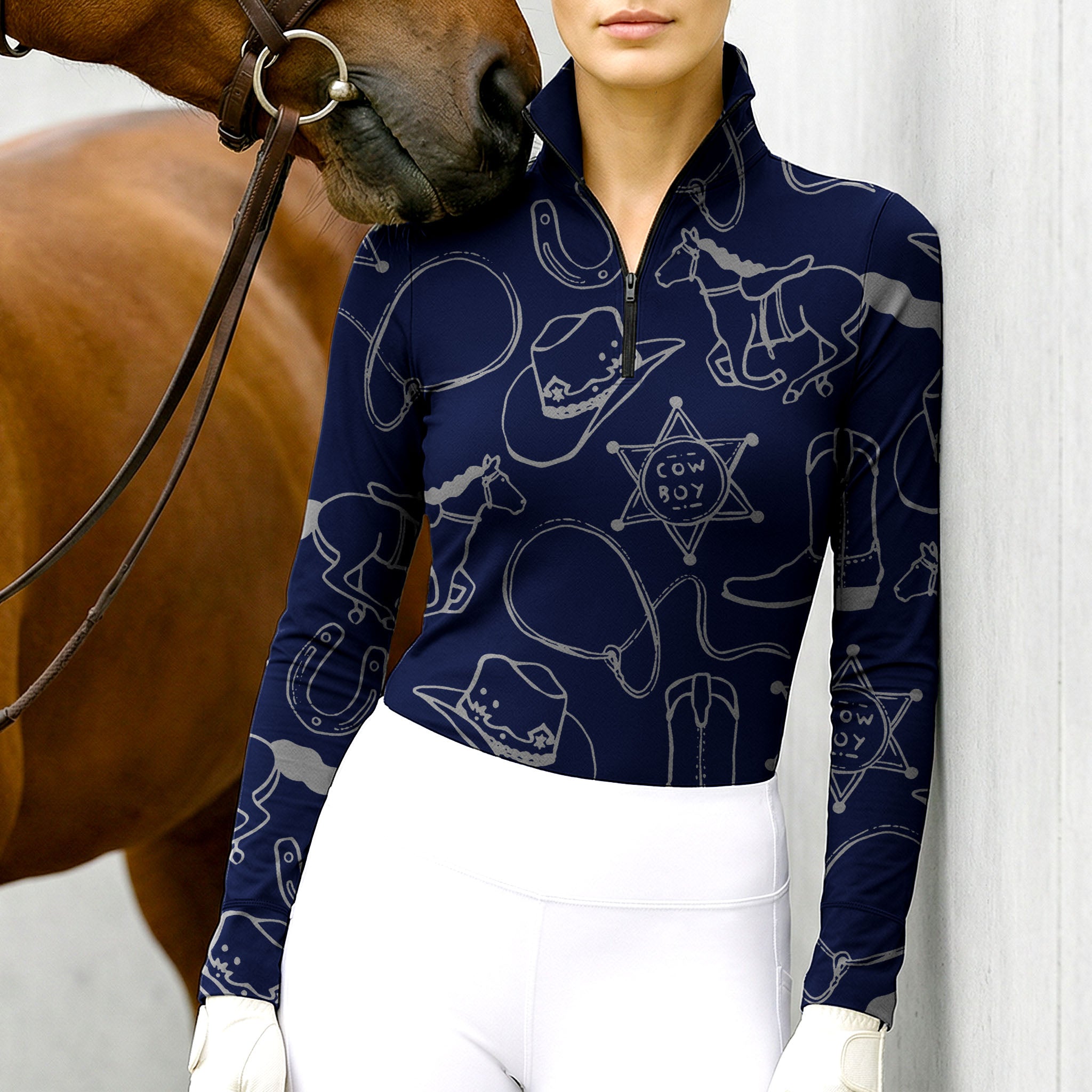 Woman wearing RIDER ATELIER cowboy western navy blue quarter-zip top with a chestnut horse