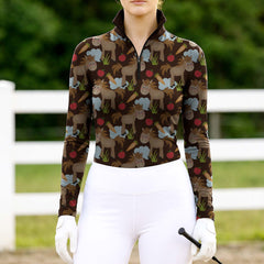 Woman wearing RIDER ATELIER cute cartoon horse dark brown quarter-zip top at the outdoor pasture