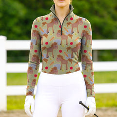 Woman wearing RIDER ATELIER cute cartoon horse sage green quarter-zip top at the outdoor pasture