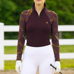 Woman wearing RIDER ATELIER equestrian tack color block quarter-zip top at the outdoor pasture