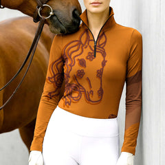 Woman wearing RIDER ATELIER floral horse head quarter-zip top with a chestnut horse

