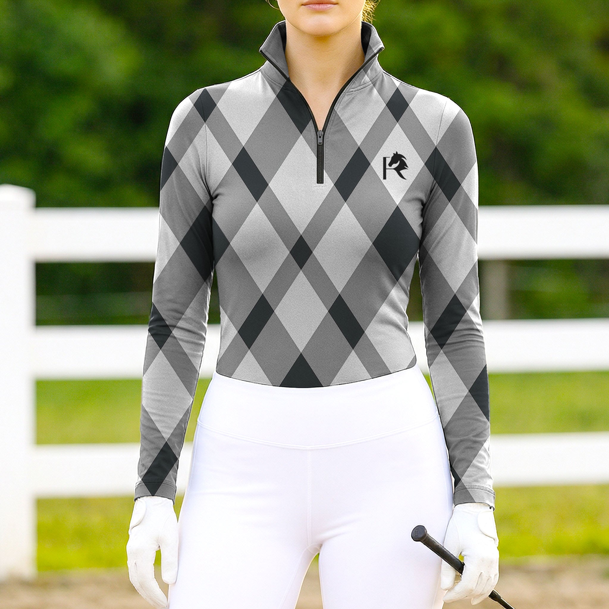 Woman wearing RIDER ATELIER gray argyle quarter-zip top at the outdoor pasture