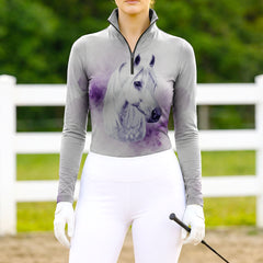 Woman wearing RIDER ATELIER dapple grey horse watercolor quarter-zip top at the outdoor pasture

