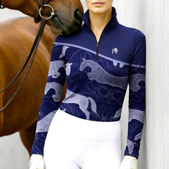Woman wearing RIDER ATELIER jumping horse floral quarter-zip top with a chestnut horse