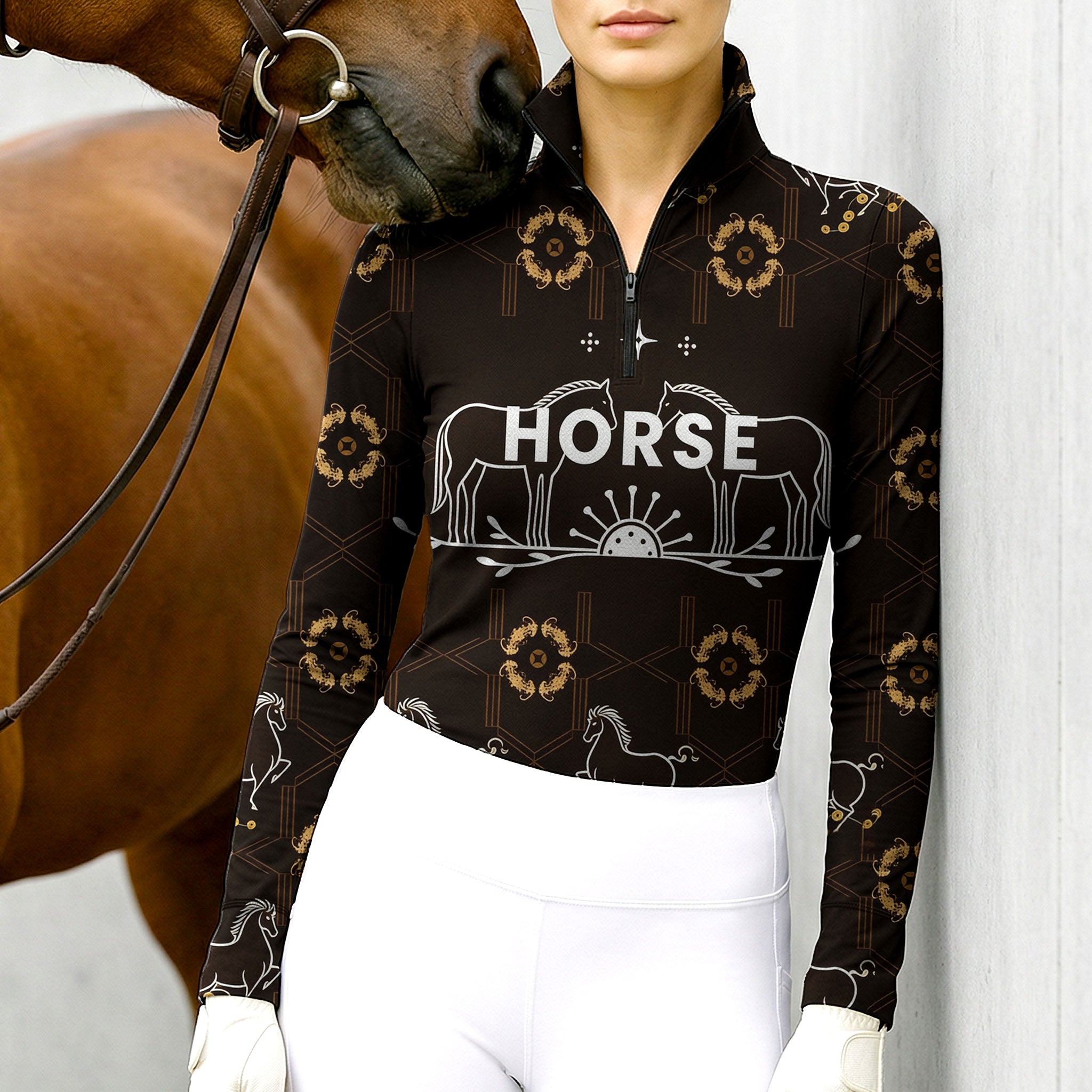 Woman wearing RIDER ATELIER luxury horse motif quarter-zip top with a chestnut horse