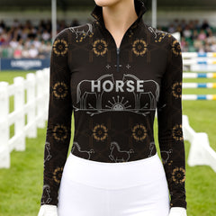 Woman wearing RIDER ATELIER luxury horse motif quarter-zip top at the show jumping arena