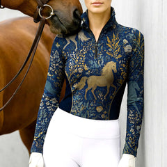 Model wearing the RIDER ATELIER Midnight Blue Mythical Horse & Floral Riding Top at the stable, with a chestnut horse, highlighting the print’s magical texture

