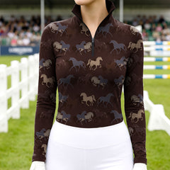 Woman wearing RIDER ATELIER multi horse silhouette chocolate quarter-zip top at the show jumping arena