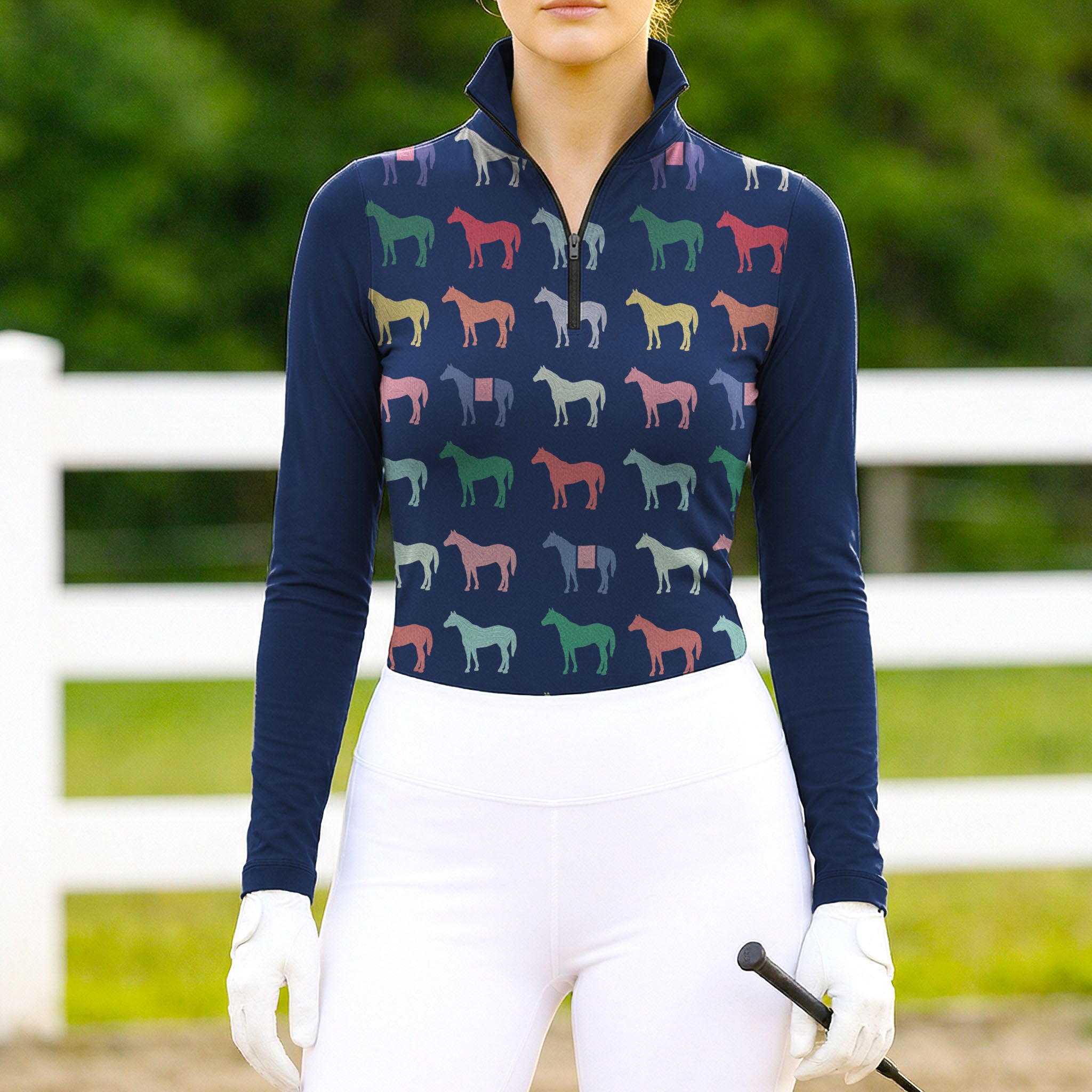 Woman wearing RIDER ATELIER multicolor horse silhouette navy quarter-zip top at the outdoor pasture