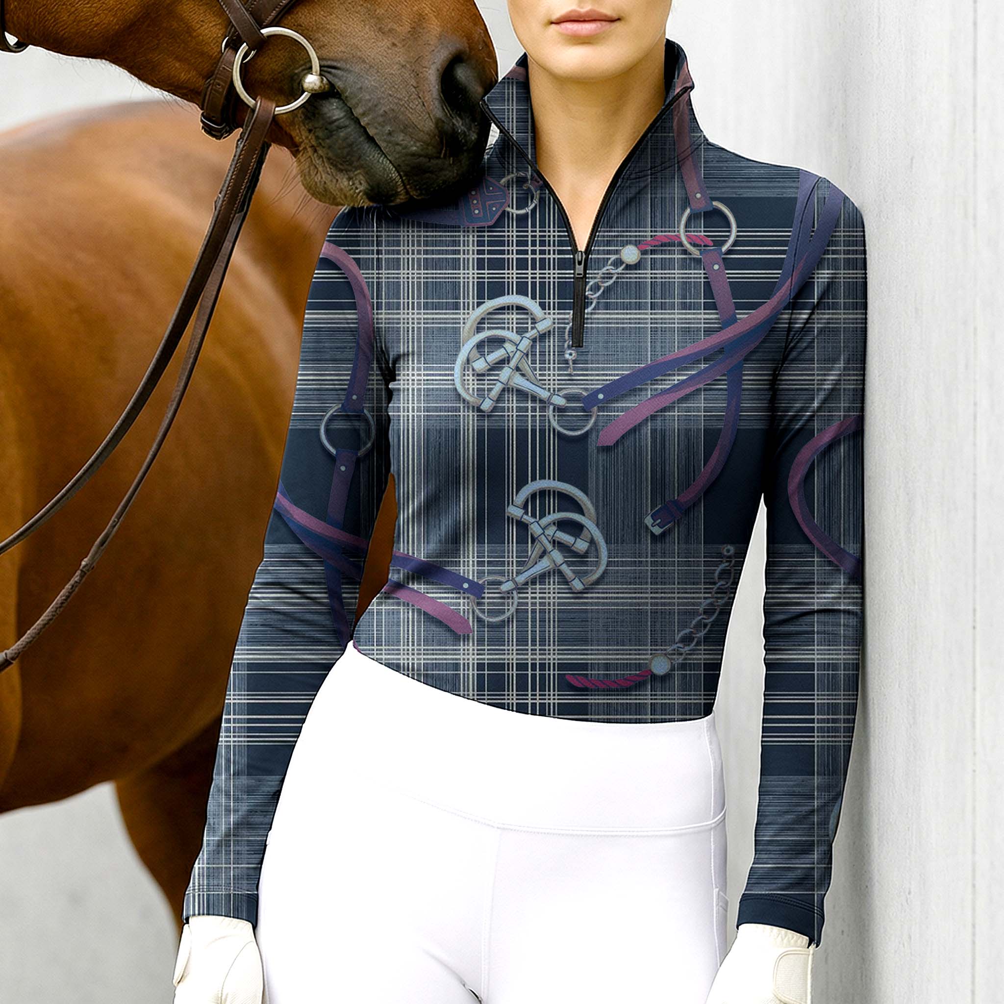 Woman wearing RIDER ATELIER plaid snaffle bit navy quarter-zip top at the barn with a chestnut horse