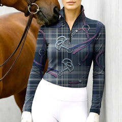Woman wearing RIDER ATELIER plaid snaffle bit navy quarter-zip top at the barn with a chestnut horse