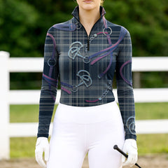 Woman wearing RIDER ATELIER plaid snaffle bit navy quarter-zip top at the outdoor pasture