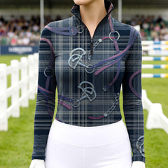 Woman wearing RIDER ATELIER plaid snaffle bit navy quarter-zip top at the show jumping arena